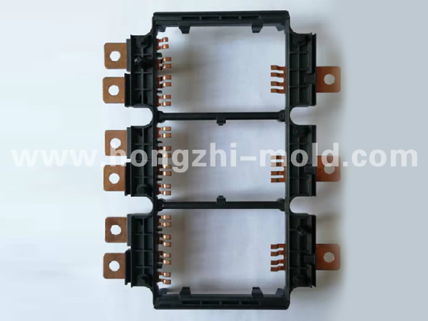 Injection molded embedded metal parts